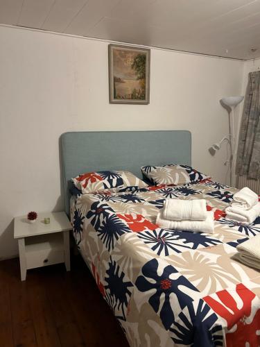 a bedroom with a bed with a colorful comforter at Pine Haven in Odense