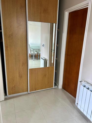 a sliding door with a mirror in a room at Lofts & Suites in Rosario