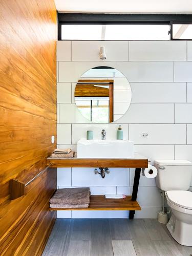 a bathroom with a sink and a toilet at Oleadas Maderas in San Juan del Sur