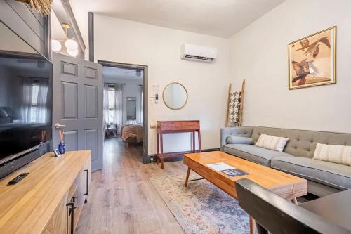 a living room with a couch and a table at High end 1B apt laundry 10ft ceilings king bed in Wilmington