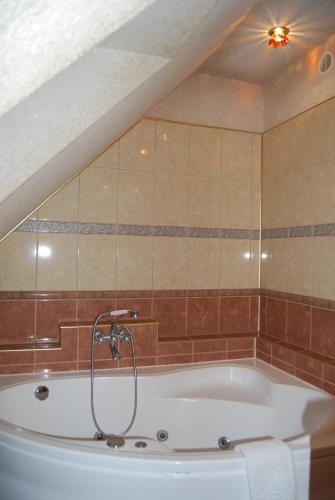 a bath tub in a bathroom with a ceiling at Villa Europa in Mielno