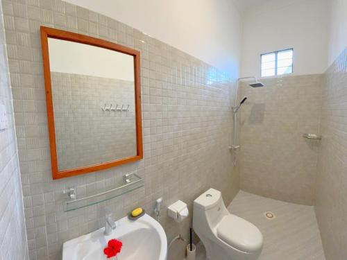 a bathroom with a toilet and a sink and a mirror at Outdoor Cinema Group Friendly Retreat in Pingwe