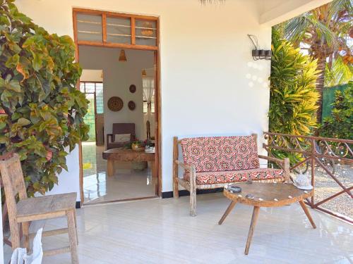 a living room with a couch and a table at Outdoor Cinema Group Friendly Retreat in Pingwe