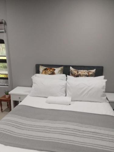 a bed with two cats sitting on top of it at Le Caille, St Lucia Two bedroom unit in St Lucia