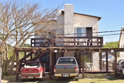 a house with cars parked in front of it at Los Horneros Aparts - La Aguada in La Paloma