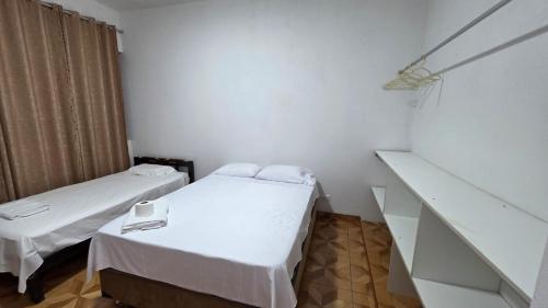 a small room with two beds and a staircase at Jorge Chavez Hostel in Lima