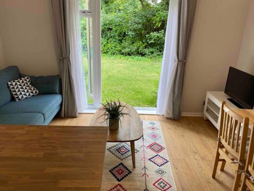 a living room with a couch and a large window at Beautiful 1 Bedroom Flat Close to the City Centre in London