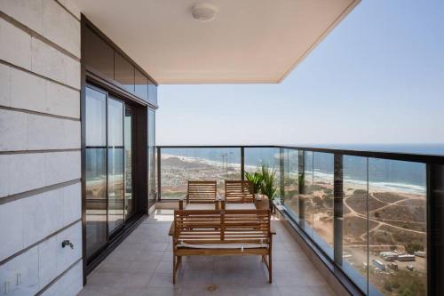 Un balcón con sillas y vista al mar. en O&O Group- Magical 4BR APT With Panoramic Sea View, en Bat Yam