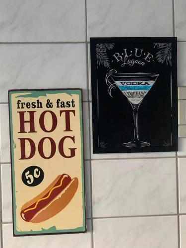 two hot dogs and a hot dog sign on a wall at Apto amplo próximo Casa Grande Hotel Resort in Guarujá