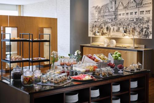 a buffet of food on a table in a room at NH Leipzig Messe in Leipzig