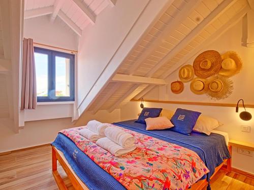 a bedroom with a bed with blue sheets and a window at Duplex 2 chambres Baie Orientale, piscine, clim, WiFi - FR-1-734-41 in Orient Bay