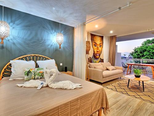 a bedroom with a large bed with a painting on the wall at Studio cosy à Anse Marcel avec terrasse et climatisation - FR-1-734-47 in Anse Marcel 
