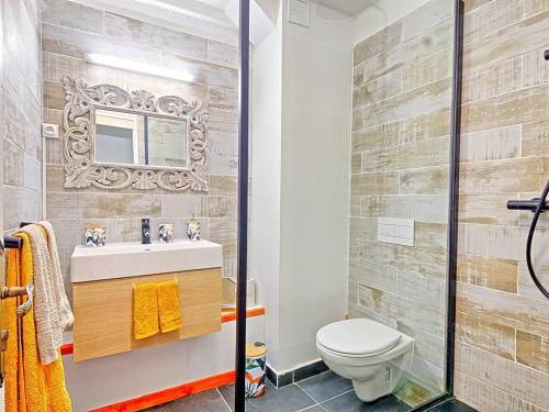 a bathroom with a toilet and a sink and a mirror at Superbe appartement 2 chambres à Anse Marcel, 400m des plages, activités nautiques incluses - FR-1-734-44 in Anse Marcel 