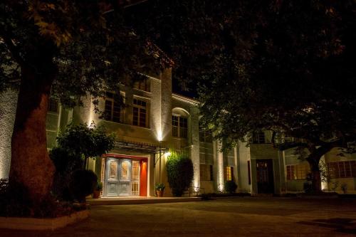 a building with a lit up door at night at Hotel Oiti in Loutra Ipatis