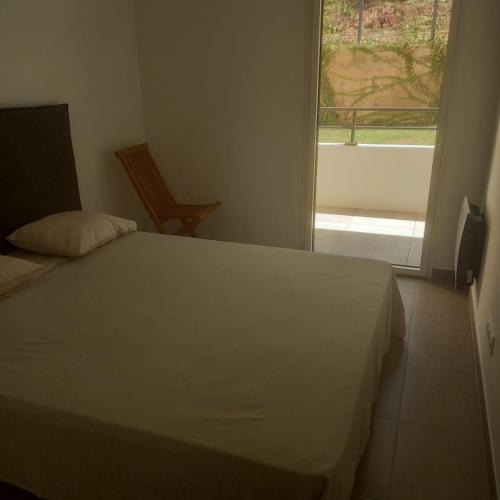 a bedroom with a white bed and a window at Charmant 2P à 5minutes de Cannes La Croisette in Le Cannet