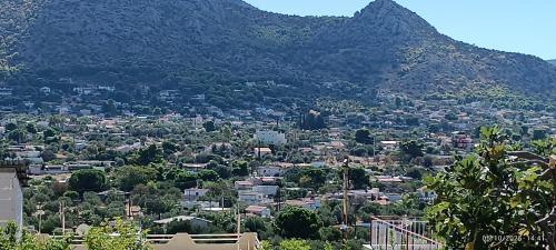 a view of a city with a mountain in the background at Irida Suite in Salamís