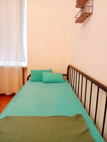 a bed with two blue pillows on it in a room at StaySpace in Graz