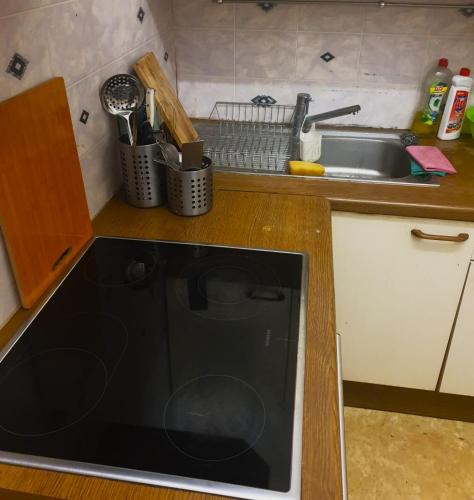 a kitchen with a sink and a black microwave at StaySpace in Graz