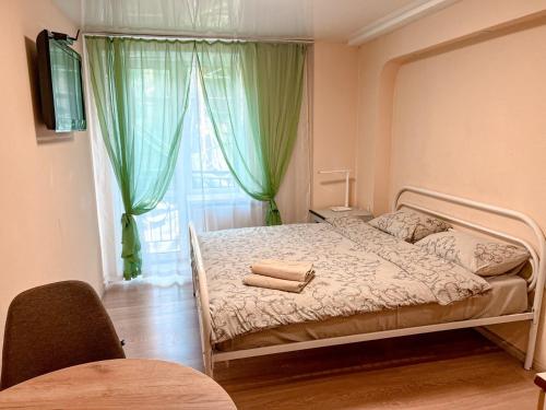 a bed in a room with a window and a bedvisor at Old Town - Andrew descent in Kyiv