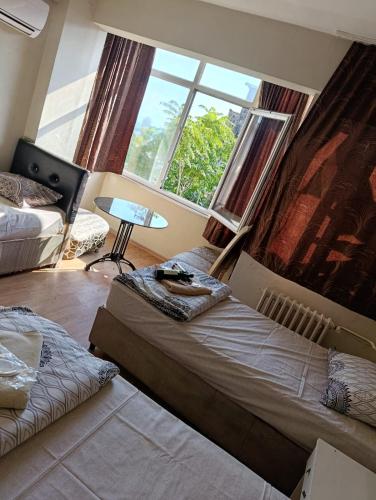 two beds in a room with a large window at Simge in Istanbul