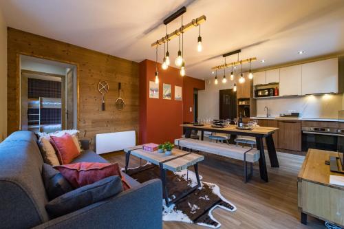 a living room with a couch and a table at 3 Vallées access & cycling Cosy 4 to 6 guests in Orelle