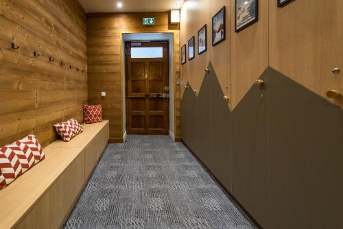 a hallway with wooden walls and a door at 3 Vallées & cycling Cosy 6 to 8 in the Alps in Orelle