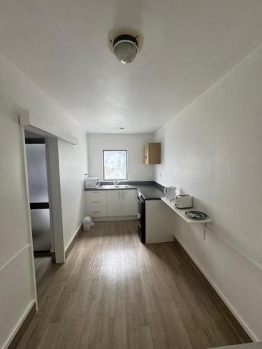 a room with a kitchen with a sink and a counter at Alcamo Motel in Hamilton
