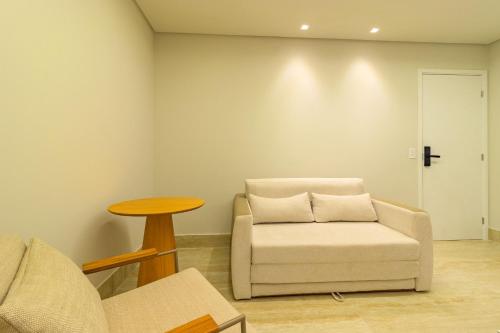 a living room with a chair and a table at Tolive Riverside HOUSI by Carpediem in Recife