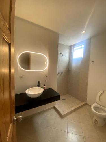 a bathroom with a sink and a toilet at Casa Bilbao in Chiconcuac
