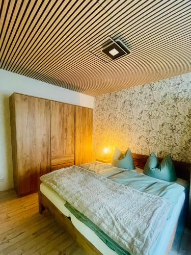 a bedroom with a bed with a wooden ceiling at Ferienwohnung auf der Spreeinsel in Spremberg