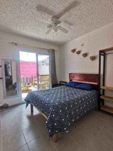 a bedroom with a bed and a ceiling fan at Departamento-Rinconcito Uxmal in Playa del Carmen
