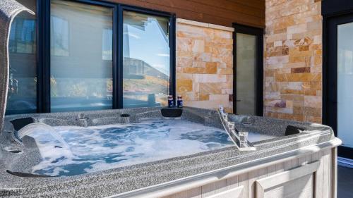 a bathroom with a jacuzzi tub with a window at Mins to Deer Valley Lift Firepit Game Room Views 5BDR Orion by AvantStay in Heber City