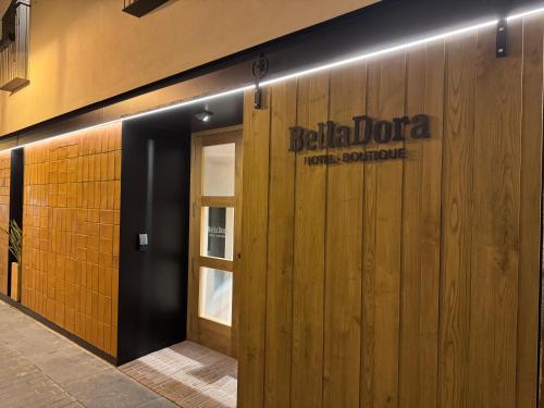 a door to a building with a sign on it at BELLADORA Hotel Boutique in Lloret de Mar