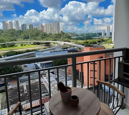 a balcony with a table and a view of a city at 1107 Ponte Laguna, Pq Burle Marx, Apto 1 dorm e Varanda in Sao Paulo