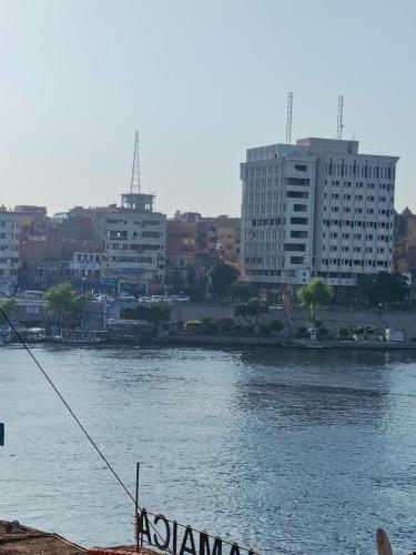 a view of a river with buildings in the background at Jamaica Guest House in Aswan