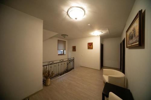 a hallway with a staircase with a couch and a light at Pensiunea Rezkakas in Balvanyos