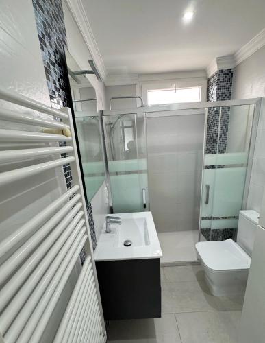 a bathroom with a sink and a toilet at BEACH FRONT APARTMENT in CALA MARSAL with the SEA VIEW ! in Portocolom