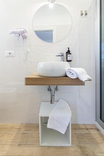 a bathroom with a sink and a mirror at Greco Rooms in Pompei