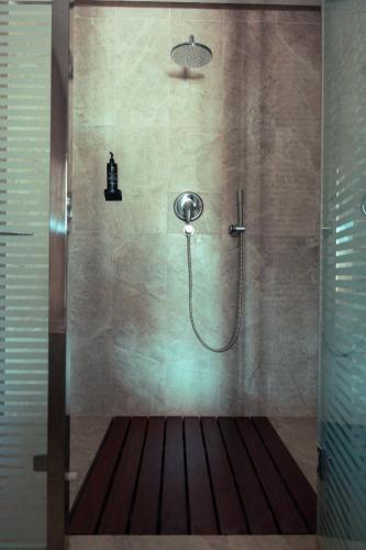 a shower with a shower head in a bathroom at Tamerza Palace By Odyssée in Tamaghzah