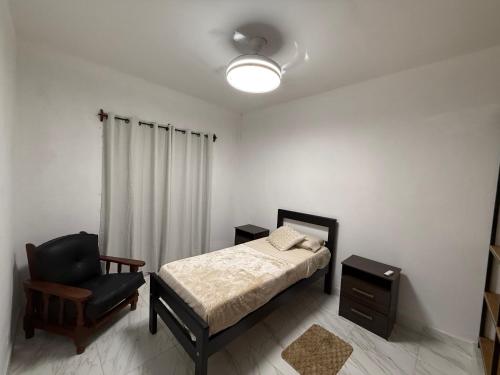 a bedroom with a bed and a chair at Departamento en Zona Norte A ESTRENAR con hermosa vista in Salta