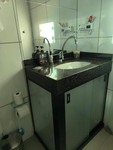 a bathroom with a sink and a mirror at Refúgio Black in Sabará