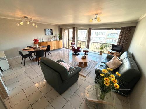 a living room with two couches and a table at Villa Elise in Ostend