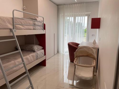 a bedroom with a bunk bed and a desk with a chair at Casa Vacanze Villa Fiorenza in Santa Maria La Carità