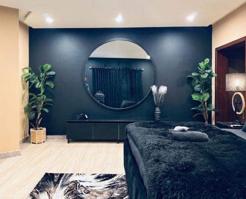 a bedroom with a large mirror and a bed at WildWest by 2ndHome in Rawalpindi