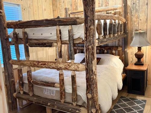a bedroom with a wooden bunk bed in a cabin at Sheep Creek Ranch Apartment in Cliff Lake