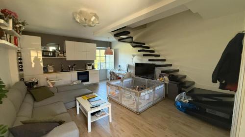 a living room with a spiral stair in a room at Casa Rachele in Arezzo