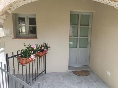 two potted plants on a wall next to a door at Casa Rachele in Arezzo