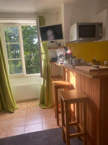 a kitchen with a counter and a window at Studio pour 1 personne au cœur du Perche in Rémalard en Perche