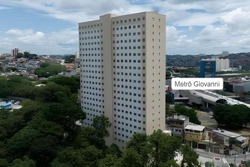 a tall white building with a sign on it at 313 Vibra e Metrô Giovanni Gronchi Vista para marginal 1 dormitório in Sao Paulo