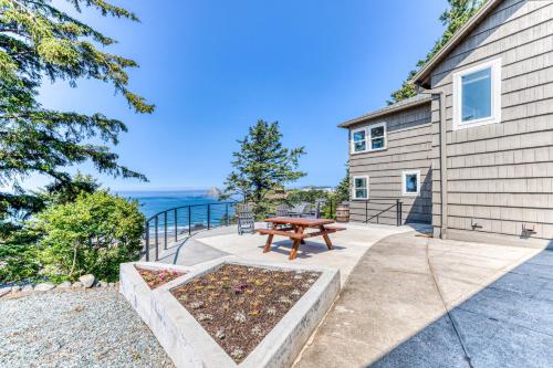 a patio with a picnic table next to a house at Oceanside Skies in Oceanside